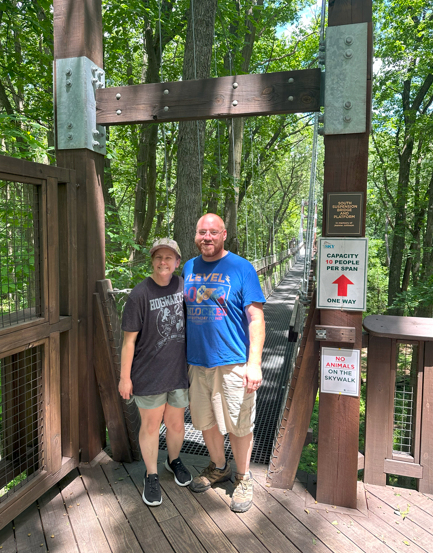 Carl LaLonde on a wooden bridge dressed for a formal event